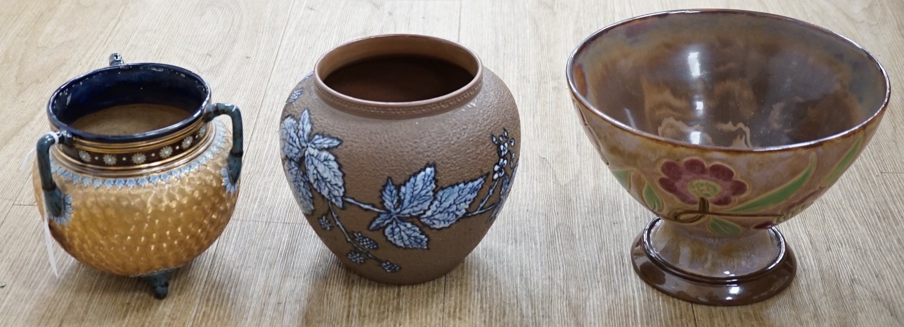 A Royal Doulton Lambeth pedestal bowl, Doulton plant pots, a vase and a three handled vase. Condition - good